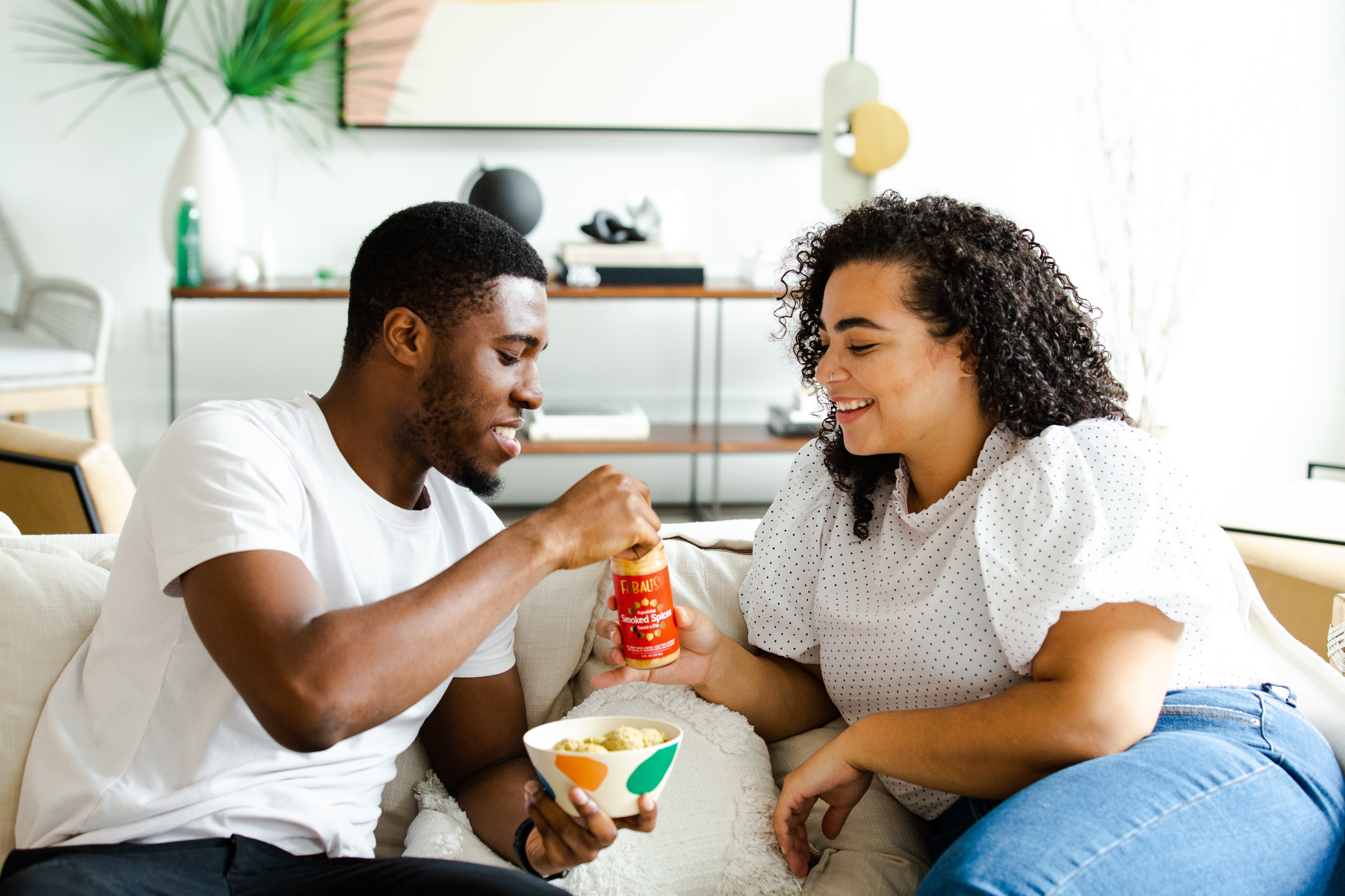 A couple having a relaxed conversation on the couch